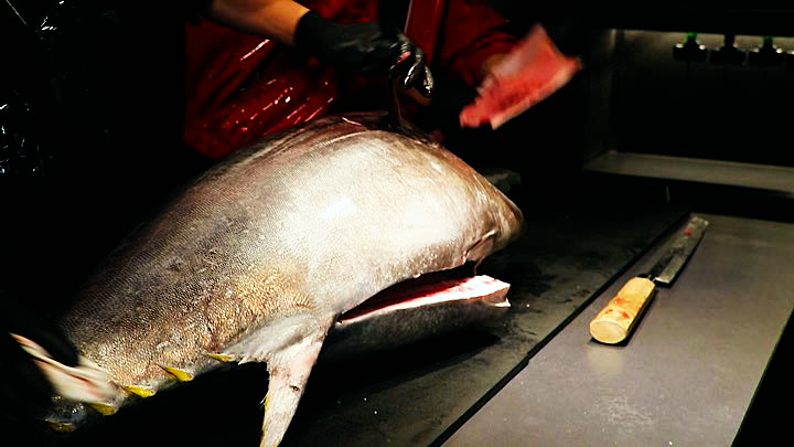 The first cuts along the back of the tuna
