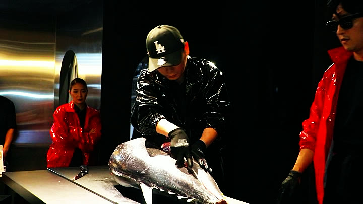 A chef cutting into the tuna