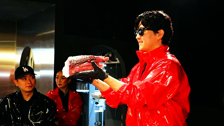 A block of tuna held up for the room to see