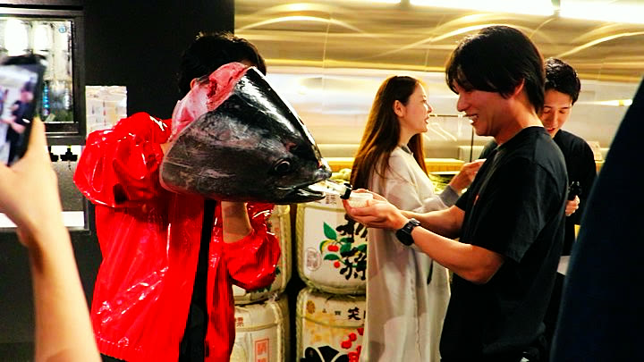 Sake poured from the tuna head into a guest's cup