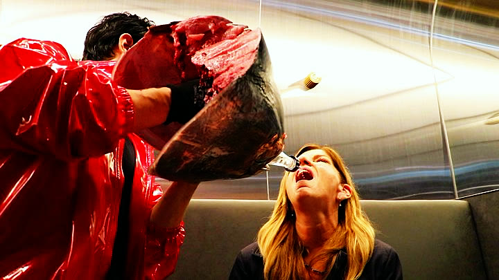 A guest drinking sake poured through the tuna head